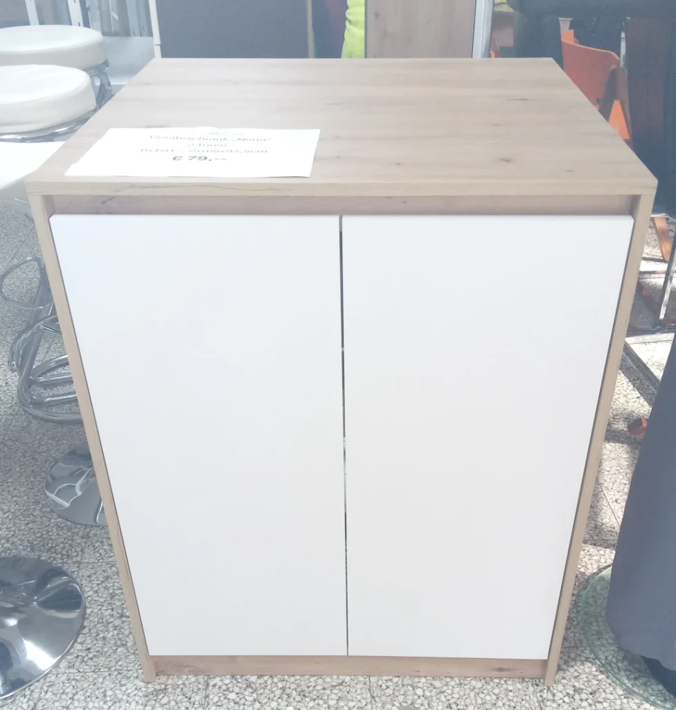 Bild des Waschmaschinen-Überbauschrankes. Vorne mit 2 Türen in weiß, Oberseite und links und rechts die Korpus-Seiten sind in Eichen-Dekor.